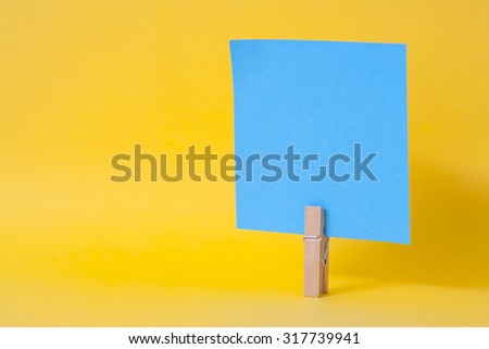 paper notes and clothespins isolated on yellow background
