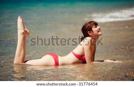 Young pretty girl lying by the sea