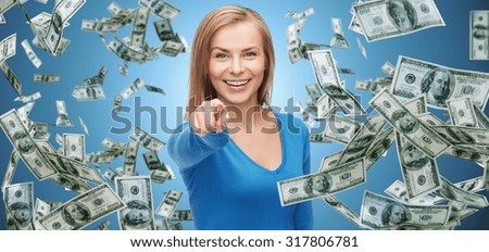 business, money, finance, people and gesture concept - smiling woman with dollar cash money pointing finger on you over blue background
