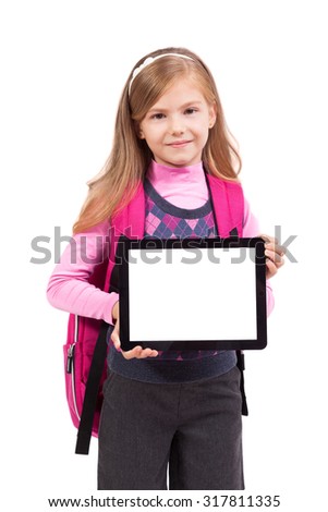 school girl with a tablet in hands looking at the camera and smiling, picture with depth of field and artistic blur