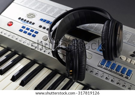 Headphones on synthesizer close up