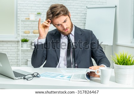 Tired businessman at work in office