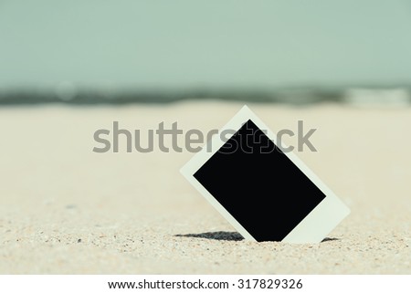 Retro Photo Of Blank Instant Photo Card On Beach Sand In Summer