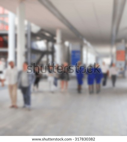 People visit a trade show, generic background, intentionally blurred post production.