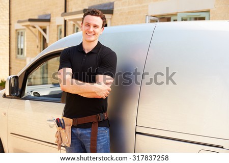 Portrait of a young tradesman by his van Royalty-Free Stock Photo #317837258