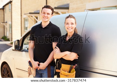 Portrait of male and female trade workers by a van Royalty-Free Stock Photo #317837474