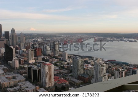Seattle downtown, harbor, nad Mount Raineer viewed from the Space Needle after sunset