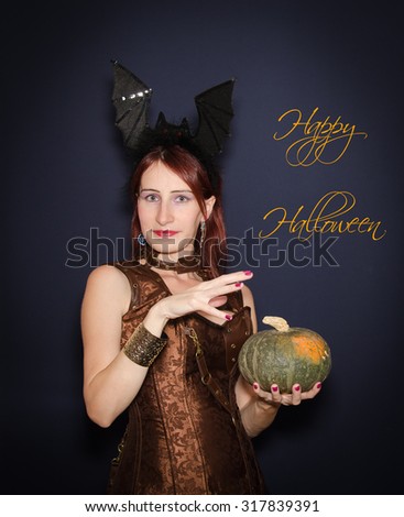 Card of happy halloween with happy woman and pumpkin isolated on blue background.