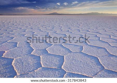 The world's largest salt flat, Salar de Uyuni in Bolivia, photographed at sunrise. Royalty-Free Stock Photo #317843843