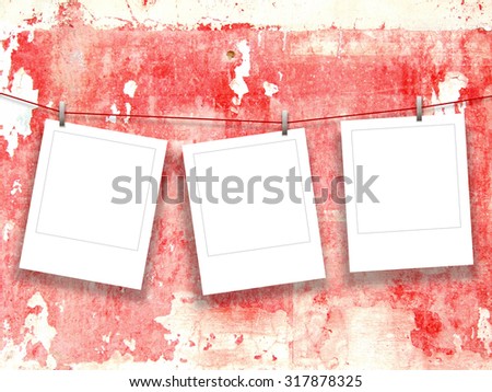 Digital background: three hanged instant photo frames with clothespins-red black gray white-scratched plastered concrete wall background