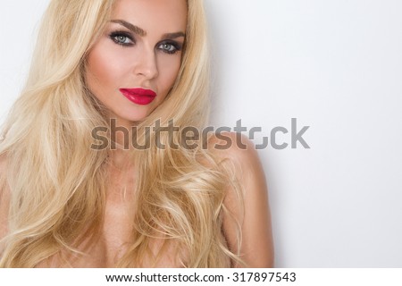 Beauty face of the young beautiful woman - isolated on white background. Gorgeous female portrait with slicked blond hair. Young adult girl with healthy skin. Pretty lady with fashion eye makeup. Royalty-Free Stock Photo #317897543