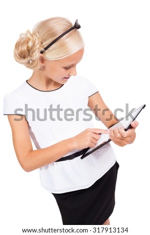 school girl with a tablet in hands  smiling, picture with depth of field and artistic blur