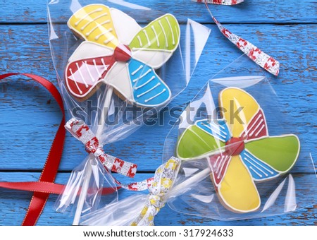 Homemade homemade gingerbread cookies in the form of multicolored pinwheels on the wooden table. Space for text and selective focus.