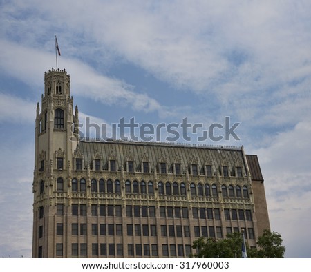 Prominent building in the San Antonio Texas skyline against a cloud filled blue sky