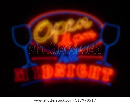Colorful neon light on pub brick wall blurred background for lighting concept