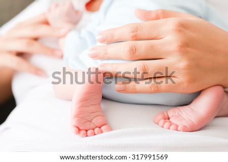 Mother protecting her newborn child Royalty-Free Stock Photo #317991569