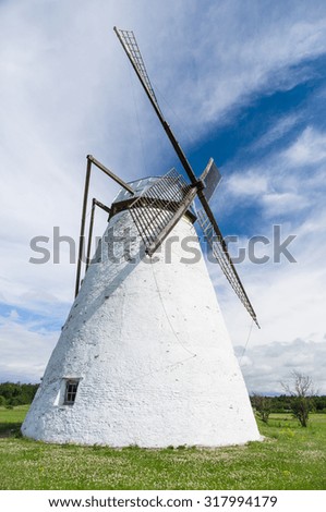 Large white windmill under blue sky