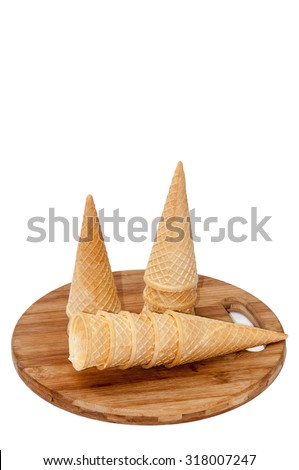 Empty ice cream cone on a wooden board.