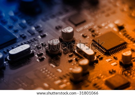 Closeup of computer plate with microchips colorized