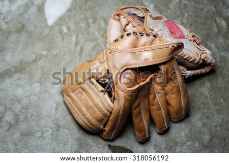 Old baseball glove with mat