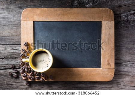 still life photography : espresso cup with coffee beans at corner of blank slate on old wood