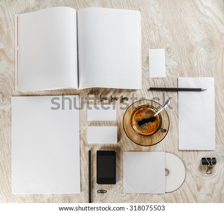 Blank stationery and corporate identity template on light wooden background. Mock-up for graphic designers portfolios. Top view.