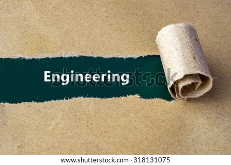 Torn brown paper on green surface with "Engineering" word.