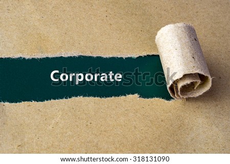 Torn brown paper on green surface with "Corporate" word.