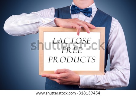 a man with a sign in his hands with the inscription lactose free products