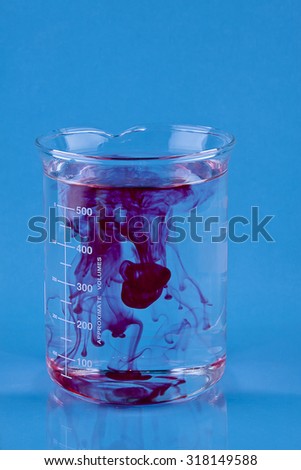 Red food coloring dropped into a Beaker of water.