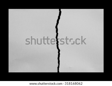 tearing paper into two pieces on black Royalty-Free Stock Photo #318168062