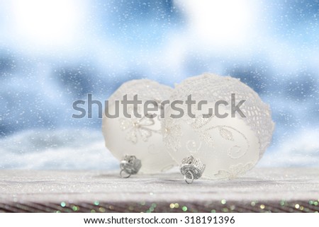 Christmas baubles on snow and clouds