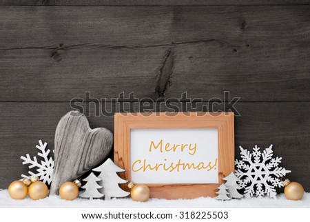 Golden Christmas Decoration On Snow. Heart, Christmas Tree Balls, Snowflake, Christmas Tree.Picture Frame With English Text Merry Christmas.Rustic,Vintage Gray Wooden Background. Black And Withe Image