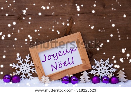 Purple Christmas Decoration On Snow. Christmas Tree Balls, Snowflakes And Christmas Tree. Picture Frame With English Text Merry Christmas. Rustic, Vintage Brown Wooden Background. 