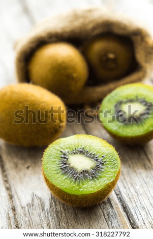Fresh Kiwi fruit on brown wooden background