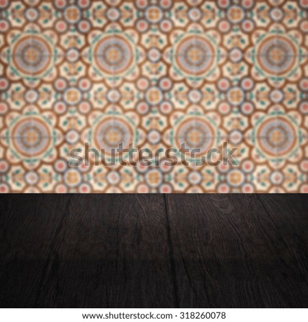 Empty wood table top and blur vintage ceramic tile pattern wall in background, Mock up template for display of your product.