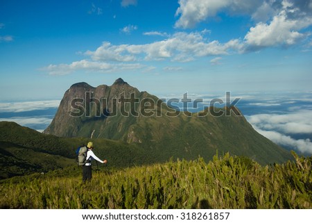 Motivated Brazilian Man Hiking with Backpack and Trekking Pole in Pico Parana State Park - Brazil Royalty-Free Stock Photo #318261857