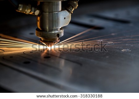 Cutting of metal. Sparks fly from laser Royalty-Free Stock Photo #318330188