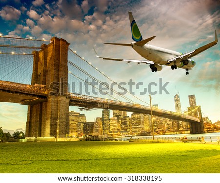 Airplane overflying Brooklyn Bridge in New York City.