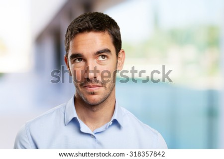 Close up of a young businessman wondering