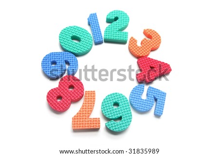 Foam Numbers Arranged in Circle on White Background