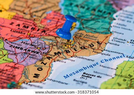 Map of Mozambique with a blue pushpin stuck Royalty-Free Stock Photo #318371054