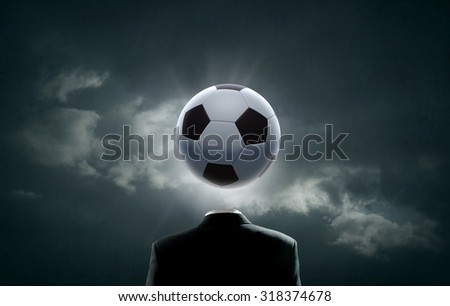 Unrecognizable man with soccer ball instead of head