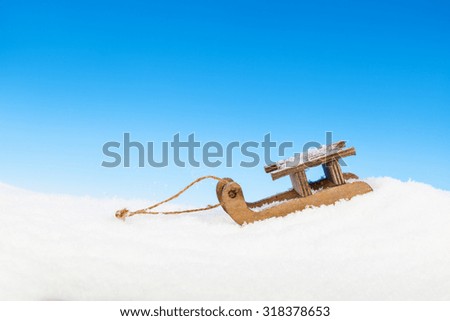 Old vintage wooden sled on blue background