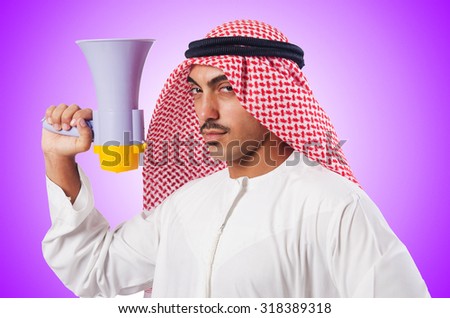 Arab man shouting through loudspeaker Royalty-Free Stock Photo #318389318