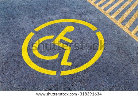 Handicap parking sign on asphalt, persons with disabilities