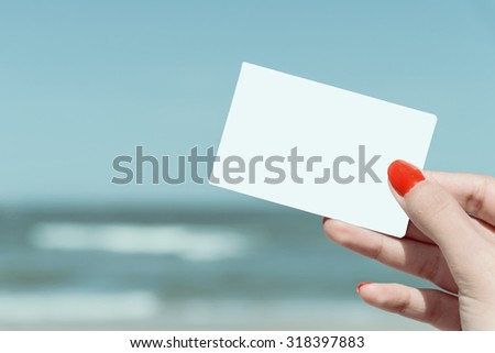 Retro Photo Of Woman Hand Holding Blank Card On Summer Beach