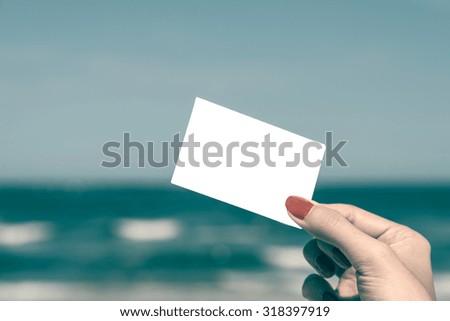 Retro Photo Of Girl Hand Holding Blank Card On Summer Beach