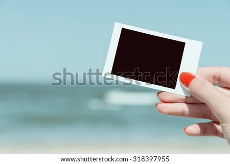 Retro Photo Of Woman Hand Holding Blank Card On Summer Beach