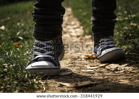 Walking on a path in a pair of sneakers